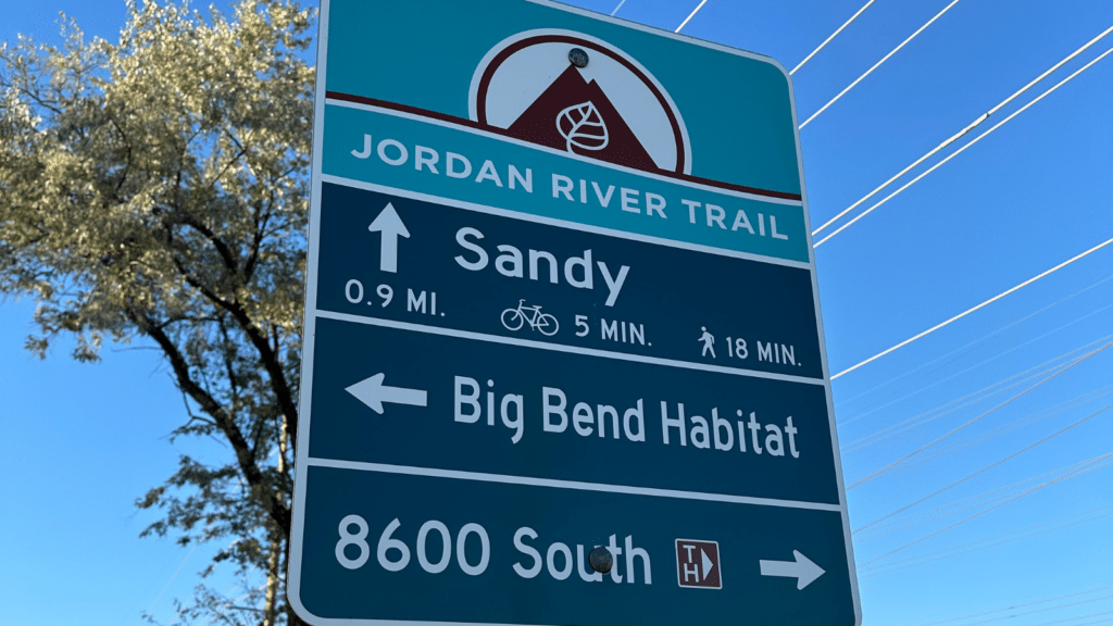 Sign along the Jordan River Trail showing directions to Big Bend Habitat